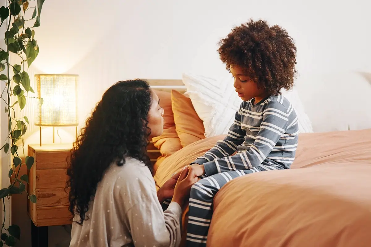 Mother comforts her son, demonstrating co-regulation skills for both child and parent.